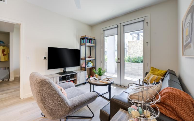 a living room with a tv and couches
