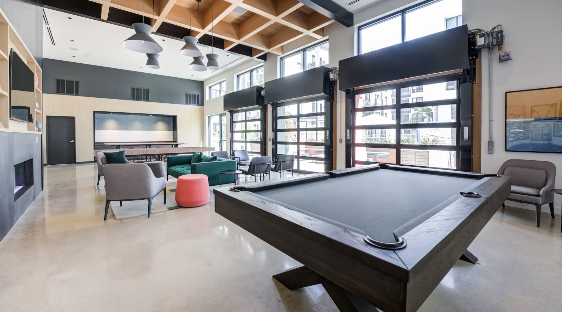 a clubroom with a pool table and chairs