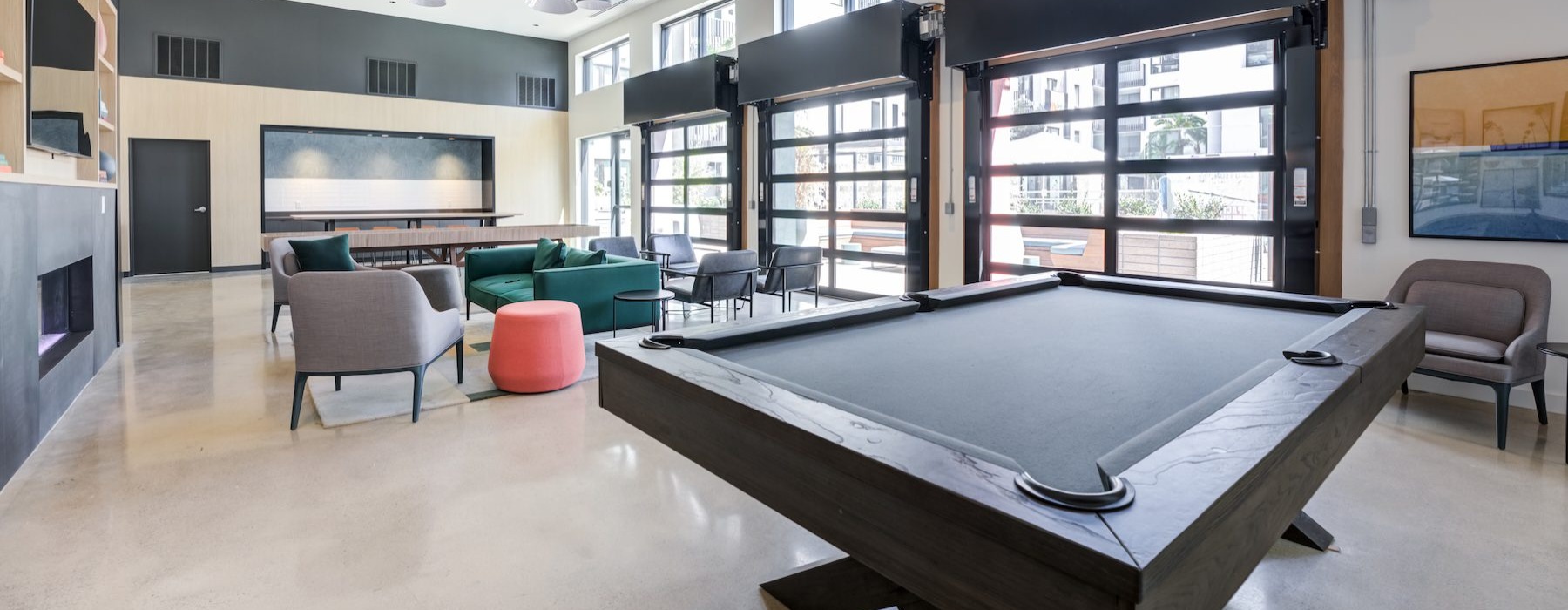 a clubroom with a pool table and chairs