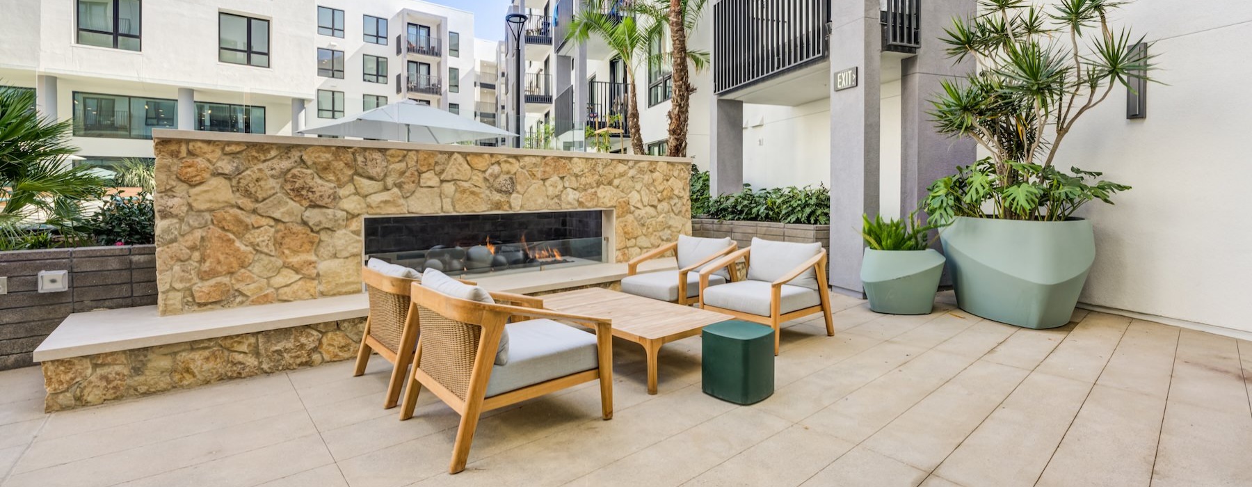 a patio with tables and chairs outside